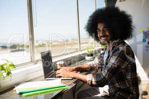 Portrait of smiling young businessman using digital tablet