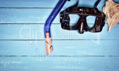 scuba mask and snorkel on a blue wooden background