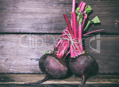 Two raw beets are tied with a rope
