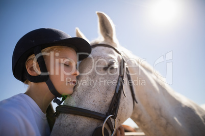 Rider girl embracing the horse