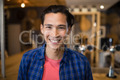 Smiling man standing near at counter