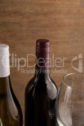 Cropped image of wineglass by bottles