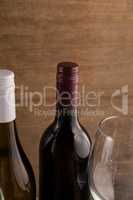Cropped image of wineglass by bottles