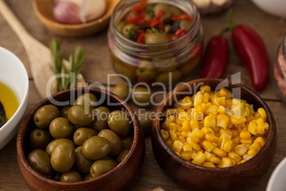 High angle view of corns and green olives