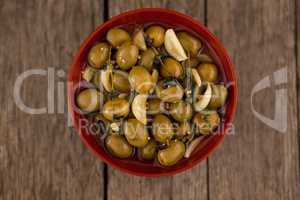 Directly above shot of olives with garlic and oil in bowl