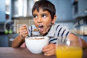 Close up of boy having breakfast at home