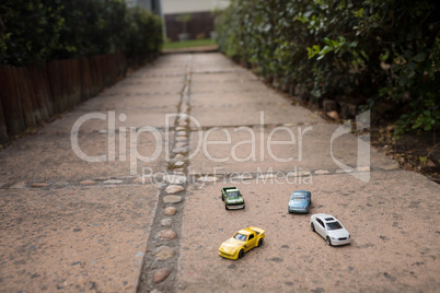 Close up of toy cars on footpath