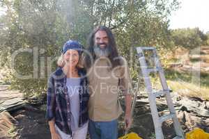 Portrait of happy couple standing together in olive farm