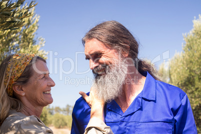 Romantic couple looking at each other in olive farm