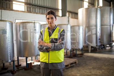 Portrait of confident technician standing with arms crossed