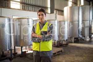 Portrait of confident technician standing with arms crossed