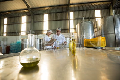 Technicians examining olive oil