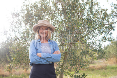 Portrait of happy woman standing in olive farm
