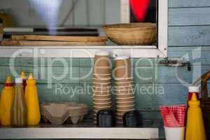Cups and condiments on table by window