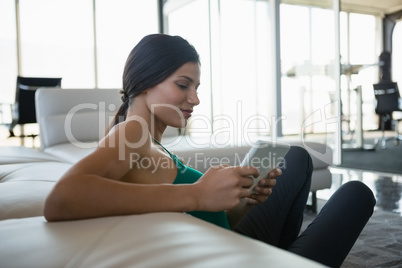 Relaxed woman using digital tablet