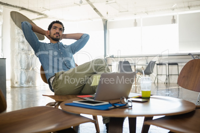 Man relaxing on chair in office