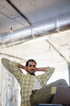 Portrait of relaxed man on chair in office
