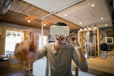 Man using virtual reality headset in restaurant