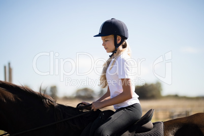 Girl riding a horse in the ranch