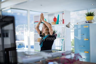 Female executive doing yoga in office