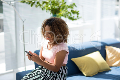 Female executive using mobile phone in the office
