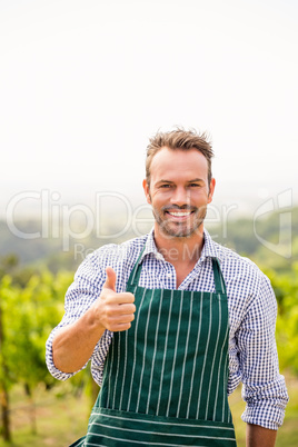 Portrait of smiling man showing thumbs up sign