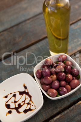 Close up of black olives by bottle