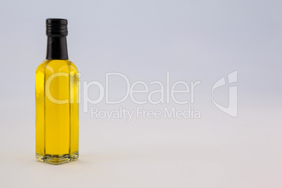 Yellow oil bottle against wall