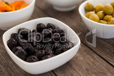 Close up dried black olives in container