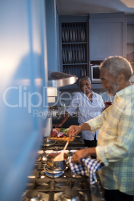 Woman looking at man preparing food