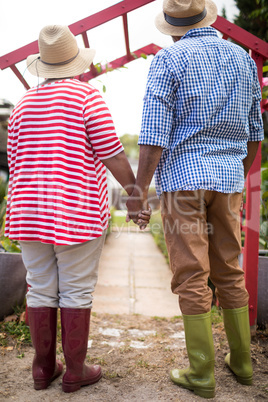 Full length of senior couple holding hands