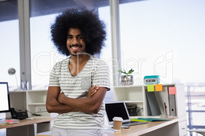 Portrait of confident man with arms crossed at office