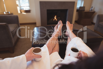Couple relaxing while having coffee in the living room