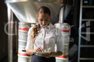 Waitress using digital tablet in bar