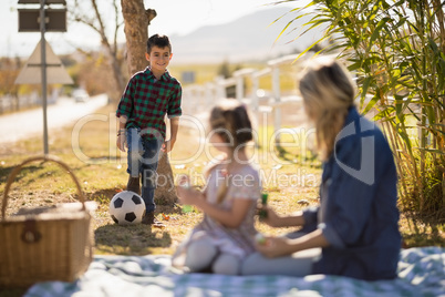 Mother interacting with kids in park