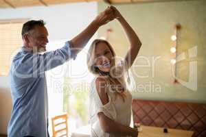 Couple dancing together in restaurant