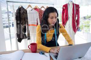 Female designer using laptop
