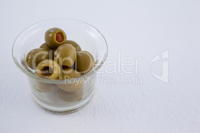 High angle view of green olives in container