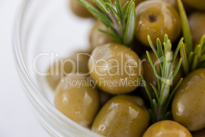 Close up of green olives with rosemary