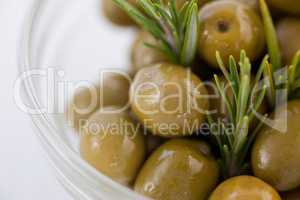 Close up of green olives with rosemary