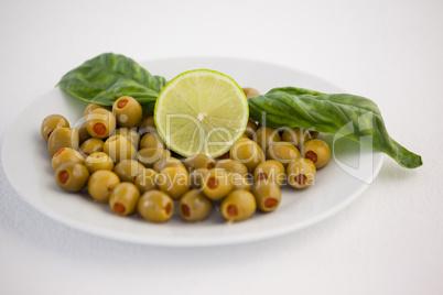 Close up of olives with lemon and herb