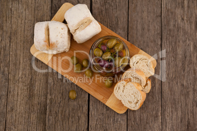 Overhead view of olives by bread