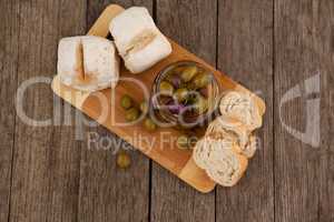 Overhead view of olives by bread