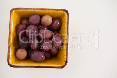 Overhead view of brown olives in bowl