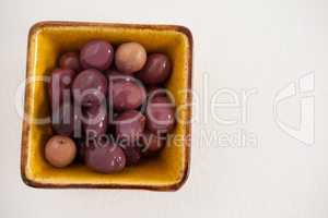 Overhead view of brown olives in bowl
