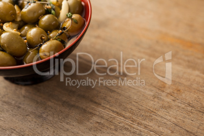 Cropped image of olives with spice in bowl