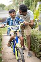 Father talking to son while cycling