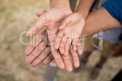 High angle view of family stacking hands