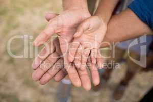 High angle view of family stacking hands