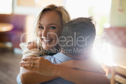 Couple embracing each other in restaurant